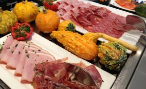 a plate of meats and vegetables on a table at Hotel Altenwerder Hof in Hamburg