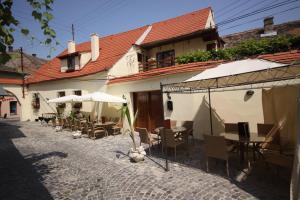 an outdoor patio with tables and chairs and umbrellas at Casa Romana I in Sibiu