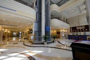 an empty lobby of a building with a large building at Al Waleed Tower Hotel in Makkah