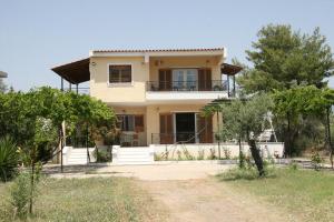 a house in the middle of a field at Villa Vlichos in Amarynthos