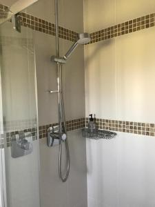 a bathroom with a shower with a glass door at Fair View in Marden +13 photos