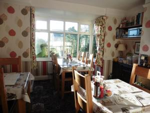 a dining room with a table and chairs and a window at Hillside Bed and Breakfast in Bedale