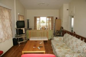 a living room with a couch and a coffee table at Villa Vlichos in Amarynthos