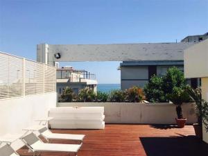 a patio with white furniture on top of a building at Hotel Principe di Piemonte in Rimini