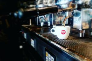 a coffee cup sitting on a counter in a coffee shop at Hotel Principe di Piemonte in Rimini