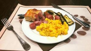 a plate of eggs and vegetables on a table at Hotel Principe di Piemonte in Rimini