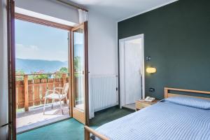Postel nebo postele na pokoji v ubytování Al Pian Garnì Hotel - B&B & Pizza