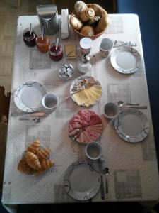 a table with various pastries and plates on it at Haus Fliri in Curon Venosta
