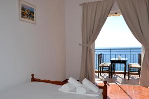 a bedroom with a bed with a view of the ocean at Villa Panorma in Qeparo