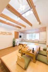 a living room with a table and chairs and a bed at Guest Villa Hakone Miyanoshita in Hakone