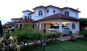 a house with a car parked in front of it at Al-Bayt Homestay in Ayer Keroh