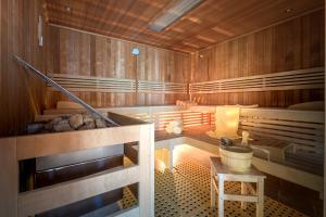 a sauna with a staircase and a table in a room at Kurzentrum Waren (Müritz) in Waren