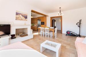 a living room with a fireplace and a dining room at Villa San Dimitrio House on the Beach in Logaras