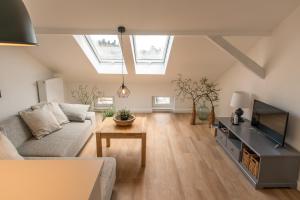 a living room with a couch and a tv at Apartment Stadtblick in Lübeck