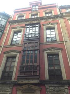 a tall red brick building with many windows at 3M VUT 519 As in Gijón