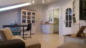 a living room with a table and a kitchen at 3M VUT 519 As in Gijón