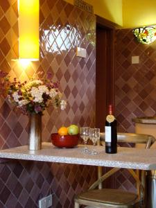 a counter with two glasses and a bottle of wine at Lake View Studios in Nairobi