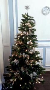 a christmas tree with lights on it in a room at Fewo Meissen in Meißen