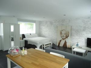 a living room with a couch and a table at B&B Sloterpark in Amsterdam