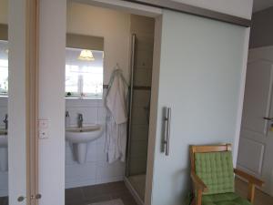 a bathroom with a sink and a shower backdoor at Pension Kölzer in Mörsdorf