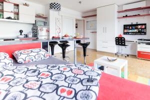 a kitchen and a living room with a bed at ★★★Red Velvet Haven | Free garage+Bikes+Coffee★★★ in Ljubljana