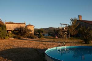 a backyard with a swimming pool and a playground at Outeiro de Setecamiños in Cuntis