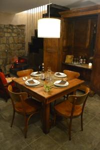 a wooden table with chairs and a dining room at Il Riuscello in Tuscania