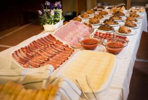 a table topped with lots of different types of food at Hotel Nadal in Lleida