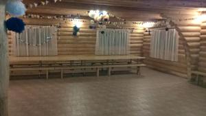 a room with two benches in a log cabin at Vizbulites in Pulkarne