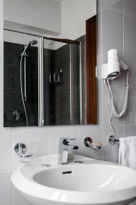 a bathroom with a white sink and a mirror at Hotel dell'Angelo in Predore