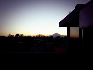 un tramonto con una montagna sullo sfondo e un edificio di Hotelito Ejido a Sanctórum Altre 17 foto