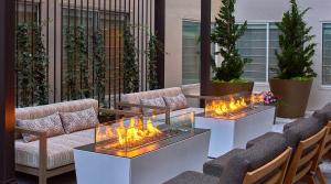 a lobby with two tables with fires on them at Hotel Zoe Fisherman's Wharf in San Francisco