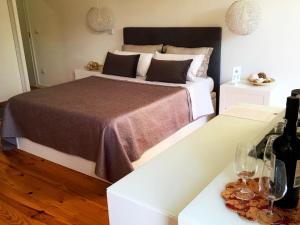 ein Schlafzimmer mit einem Bett und zwei Tischen mit Weingläsern in der Unterkunft Invictus Place in Porto