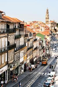 a city street with buildings and a bus at Invictus Place in Porto