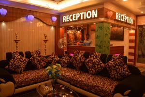 a couch in a room with a sign that reads reception at Sri Sarvesha Residency Temple view in Tiruvannāmalai
