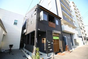 a black house on the side of a building at Nekokura Hostel in Fukuoka