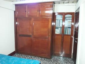 a large wooden cabinet in a room with a bed at Homestay Matagalpa in Matagalpa