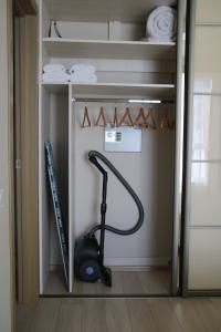 a walk in closet with a vacuum and towels at Kalinova Sloboda Home in Ivano-Frankivsʼk +2 photos