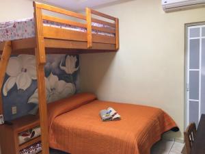 a bedroom with a bunk bed with shoes on it at Posada guitos in Xilitla +6 photos