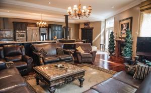 uma sala de estar com mobiliário de couro e uma lareira em JstLikeHome - Luxury Mansion & Guesthouse em Ottawa