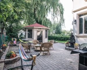 a patio with chairs and a table and a gazebo at JstLikeHome - Luxury Mansion & Guesthouse in Ottawa