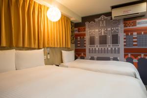 Katil atau katil-katil dalam bilik di Morwing Hotel - Culture Vogue