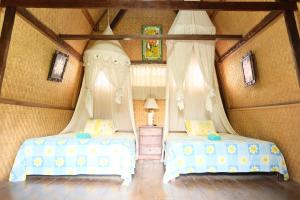 Tempat tidur dalam kamar di Kerti Beach Bungalow and Restaurant