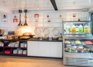 a kitchen with a counter with food and drinks at Travelodge Sukhumvit 11 in Bangkok +80 photos