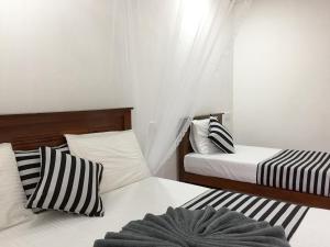 Postel nebo postele na pokoji v ubytování Aroma Heaven Homestay