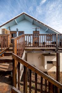 a house with a large deck with wooden railings at Healing Hands in Merom Golan