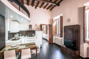 a kitchen with a dining table and a kitchen with white appliances at In Front Of Coliseum in Rome