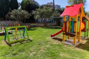 a playground with a slide in the grass at Chrispy Waterpark Resort - All inclusive in Kolymvari +89 photos