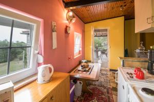 a kitchen with orange and yellow walls at Lucy in Krk