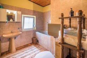 a bathroom with a sink and a toilet and a tub at Lucy in Krk +8 photos